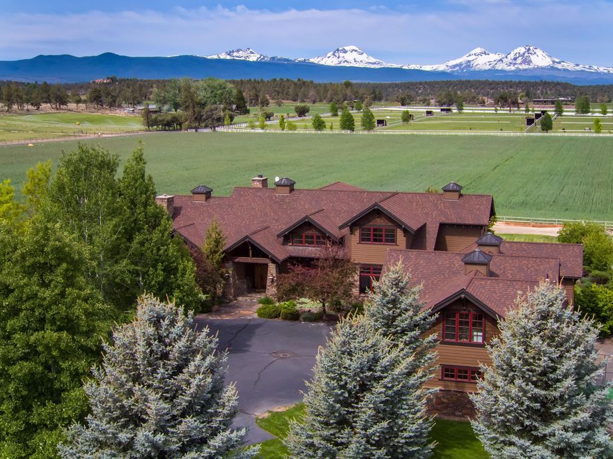 Beautiful Tumalo estate designed to maximize the panorama of the Cascade Mountains, as well as the surrounding horse and hay pastures. The great room, primary suite, study and bonus room are all on the main level. Three additional bedrooms and the loft are upstairs. A spacious well appointed guest apartment, with mountain views, is located over the 4-car garage. Designed by RickWright, the home features quality building materials and design elements, walls of windows, vaulted ceilings, beautiful wood flooring, and solid stone counters. The wonderful outdoor living in the rear of the home boasts an extended paver patio, part of which is covered, and a sunny yet protected outdoor kitchen and entertaining area with a fireplace. Located on 18.75 acres, with 15.75 acres of irrigation, pond and machine shop/storage shed. This acreage is peaceful and private, close to the hamlet of Tumalo, the Deschutes River, with access to miles of hiking and biking trails, and just a short drive to Bend.