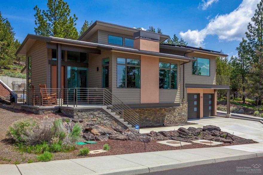 Inspired by the architecture of Frank Lloyd-Wright, this modern masterpiece has clean lines, tall ceilings and big picture windows to take in expansive views of the Cascade mountains. This recently completed custom home offers top-of-the-line features and attention to detail throughout, including gorgeous custom wood built-ins, security & full solar panel power systems. Thoughtfully designed as a forever home with master on the main, low maintenance landscaping & outdoor spaces and an elevator that stops at every floor. An ideally positioned deck off the bonus loft offers the perfect perch to take in the sun setting over the mountains... or escape to the secluded tiered patio accessed by the master suite or study for your morning coffee. Walk or bike to wonderful northwest Bend restaurants and shops from this convenient location.