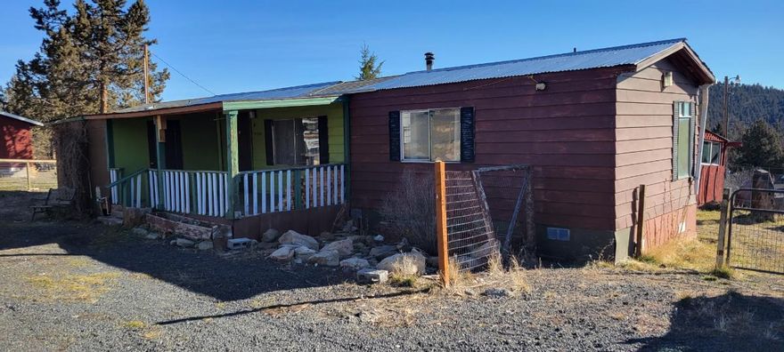 Located in Idleway Subdivision just minutes away from Prineville Reservoir. This 2 bed, 2 bath older manufactured home sits on just over 1/2 acre with views of terrain and rock croppings. Property is located approx 13 miles from Prineville's city center. Within the Idleway Subdivision there is a small convenience store, fuel station and restaurant. All kitchen appliances and washer/dryer included. Home and structure do need work, although could make a great get-a-way or remove the manufactured home and start fresh. Additional information available.