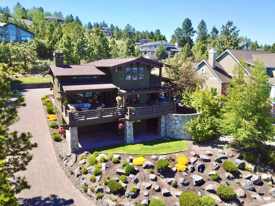 Welcome to your sanctuary atop Awbrey Heights! Revel in breathtaking easterly views from your secluded deck, perfect for peaceful mornings or hosting gatherings with a view of our 4th of July fireworks! Inside, a cozy gas fireplace and expansive vistas welcome you into this beautiful and spacious great room with high ceilings. Discover culinary delights in this chef's kitchen featuring sleek slab countertops, a generous center island, and top-of-the-line stainless steel appliances, including a double oven and 6-burner range, all perfect for entertaining friends and family. Other features include a wine and beverage fridge, walk-through pantry, and dedicated laundry room. The lavish main-level primary suite offers deck access. Upstairs, a generous secondary suite with views awaits. Downstairs, indulge in a two-bedroom bonus area with a gym and a double office. With copious storage options throughout and defensible space for added safety, embrace peace of mind in your custom retreat!