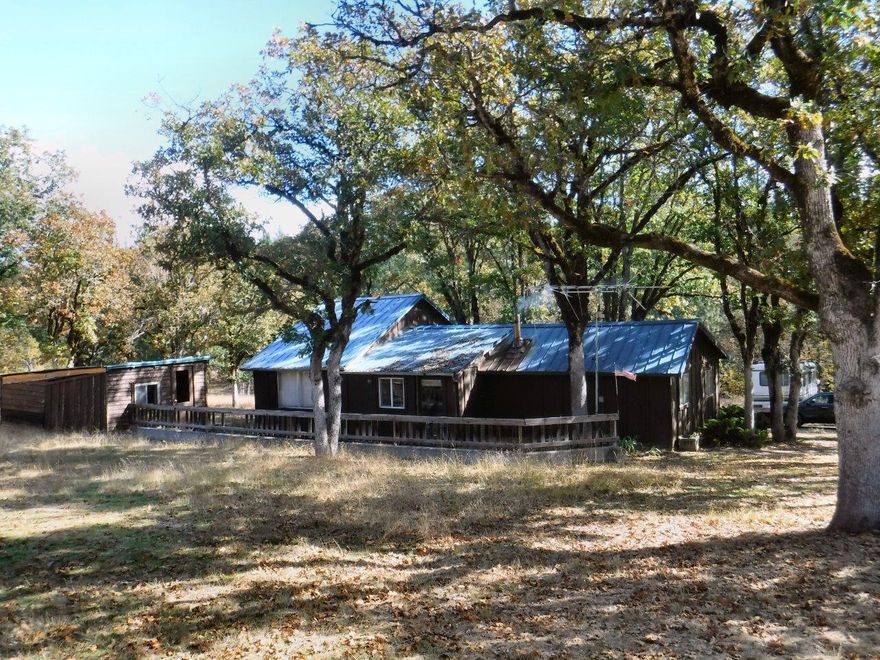 Beautiful homesite or investment for future subdivision. 8.51-Acres inside UGB, mostly useable land with seasonal creek, pasture, 2-bedroom cabin rents for $650 per month, water and city sewer available for future development. Priced to sell.