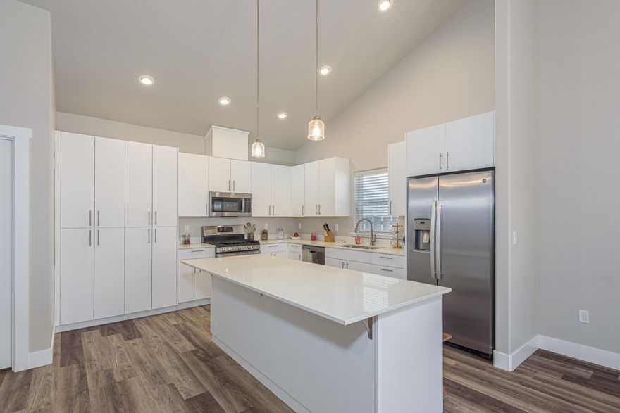 Welcome to this beautifully maintained, single-level home in the heart of LaPine. Situated in a quiet neighborhood with NO HOA, this property offers a perfect blend of modern upgrades & comfort, ideal for families, investors or those looking to downsize. With a spacious, open layout and a fenced, landscaped backyard, timed, front & back sprinklers for ease of care. this home is move-in ready. Featuring a stylish kitchen with stainless steel appliances, soft-close drawers & cabinets & stunning quartz countertops, it's perfect for both entertaining & cooking. Spacious airy rooms with vaulted and high ceilings and recessed lighting, creates an open and inviting atmosphere.  The living room is complete with a gas fireplace and a gorgeous floor to ceiling hearth. A heat pump ensures year-round comfort, The smart thermostat provides more convenience for you, providing both heating in the winter & cooling in the summer.