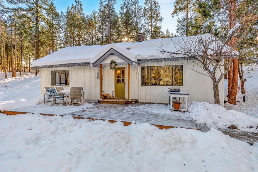 This 1185 SF 2 Bedroom / 2 Bathroom cabin sits on 1.18 lightly wooded acres at almost 4000' elevation close to Mt. Ashland Ski Area. The light and bright home has been tastefully remolded in country farmhouse style and boasts an open floor plan, centrally located wood burning stove, white washed pine ceilings and clear vertical grain old growth Douglas fir flooring. Remodeled kitchen has slate tile counters, white cabinetry, open shelving, and recessed can lighting. Master bathroom is updated with new sink, fixtures and a modern tile shower. Square footage does not include the 300 SF Sleeping/ Office loft up the spiral staircase. The detached garage is 26' x 32' and room for 2+cars, a workshop, firewood, and all types of storage and room for toys. The turn key cabin and location would make for an ideal short or long term rental, an investment property, or a great primary residence only 15 minutes from Ashland with easy access to I-5. Buyer to do due diligence for uses of the property.