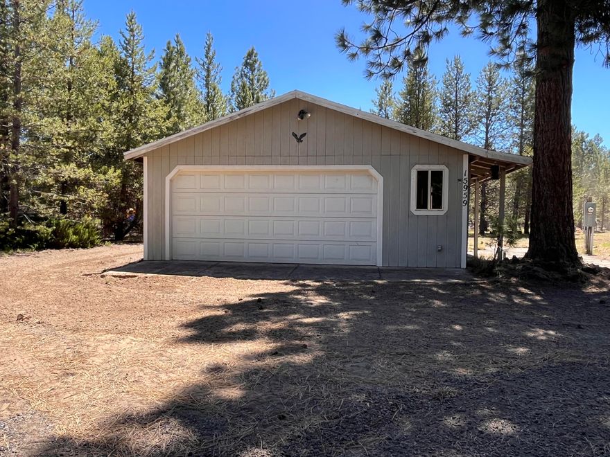 Don't miss this beautiful ready to build lot!  Property is already set up with water, septic, power and a 24x24 Garage.  Garage has a full bathroom with w/d hookups.  Property is partial fenced with two circular driveways and one full RV hookup as well as one with water and septic.  Conveniently located near the La Pine State Park and Rec Rd for an easy commute to Bend.