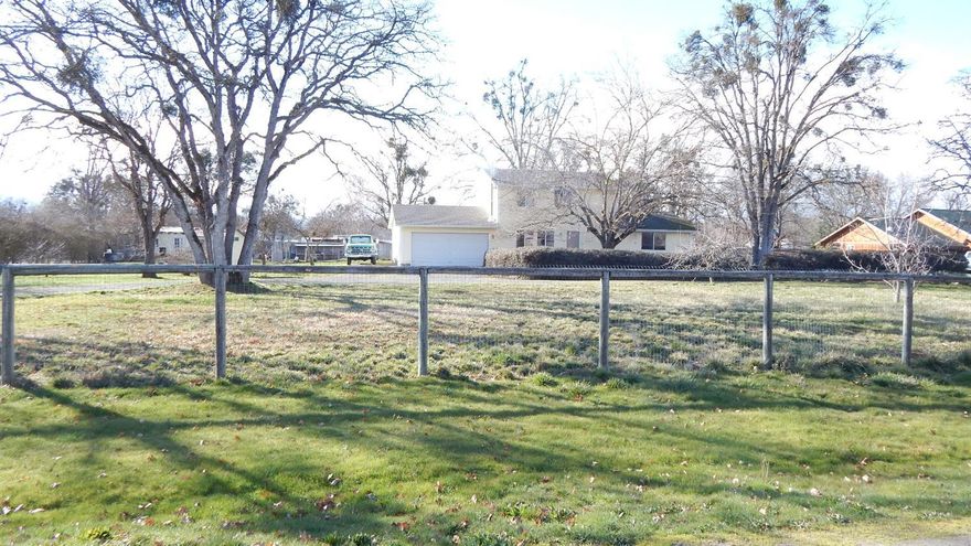 Just the perfect place! Rural land on .83 of an acre with a four bedroom plus office, 2 bath home with attached garage, built in 2004. Close to all in-town amenities. This lovely property is fully fenced, large garden area, chicken coop, fruit trees and tons of parking. There is a detached pantry/harvest room just out the back door to store all your precious canned goods grown from your own garden. Come enjoy this piece of heaven and make all your living dreams come true.