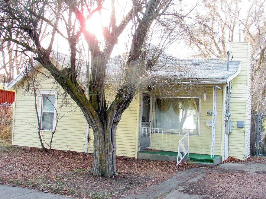 Calling all contractors and investors that want a great opportunity to make some money fixing up this 2 bedroom, 1 bath home. Many upgrades including metal siding, vinyl windows, gas fireplace, plus electric cadet heaters. Storage building in back with alley access for RV parking. Selling for CASH AS IS''.