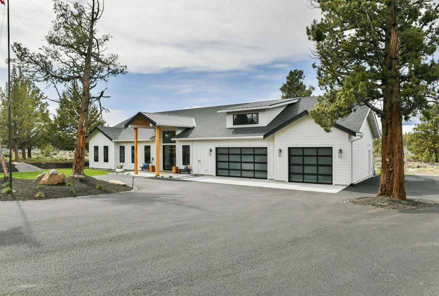 A true contemporary aesthetic and intentional site-specific design with breathtaking views of the Cascades High ceilings, open layout, beautifully finished with quartz surfaces, custom rift sawn white oak cabinetry and high-end appliances. Abundant natural light flows from the wraparound windows and doors into the central living space. The primary suite has a spa-like bath featuring heated floors, floor to ceiling porcelain tile walls, freestanding soaking tub, walk in shower, and giant walk-in closet. It encompasses the view of Black Butte and treetop view of Mt. Jefferson. The additional two bedrooms and office provide a highly functional layout. This home is luxurious living, perfect for entertaining inside with its open floor plan & top of the line finishes; or outside with expansive covered living, sitting, or dining area. 3-car garage includes a separate storage space & ample project space.  Add your  imagination to the approx  800 sq. ft. flex space above the garage.