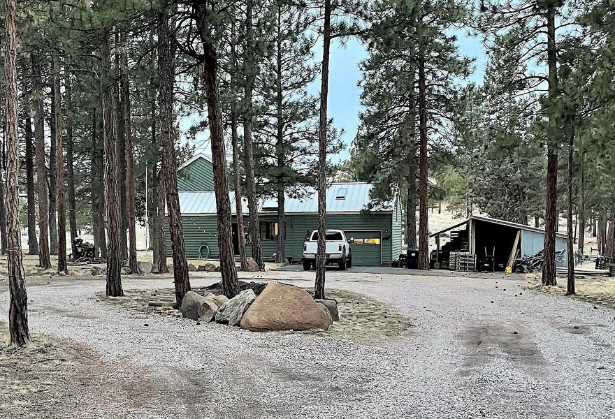 Squaw Creek Canyon cozy cabin on .91 acre! This three bedroom, two bath home is spacious in design, while offering the warmth of a cabin's touch. There is a large bonus room above the two-car garage, a circular driveway with lots of available parking, covered wood area and additional shed. Enjoy the stars while soaking in the hot tub.