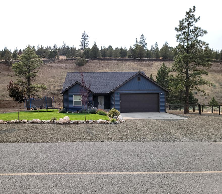 Beautiful custom home setting in a nice subdivision - incredible views. 4 bedroom 2 bath 1802sqft home built in 2007 on large lot 0.75 of an acre.Granite countertops, tile floors, open floor plan,knotty alder cabinets,island,21X22 garage,fenced dog run,large yard with underground sprinklers,landscaping, freshly painted exterior, new heatpump 2020. This is a beautiful home with many custom upgrades througout.Pride of ownership inside and out.