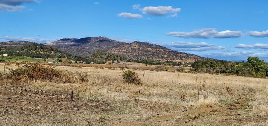 Wow! Nearly 80 acres just a short drive to Eagle Point or Shady Cove. The sale includes 4 tax lots, zoned EFU and RR5. The existing 1995 manufactured home is well cared for and is immensely private. With 2 bedrooms, 2.5 baths with large open living area, great kitchen and great views, this home would make a great rental or family property. There is also an existing barn, shop area and is nearly completely fenced for horses. 6 acres of the property have water rights from EP irrigation district. A seasonal creek runs through the property with lot of resident wildlife. There is also direct access to Hwy 62 but has not been traditionally used by the owners. Lots of area to roam here but still so close to all the conveniences. Don't miss this one!