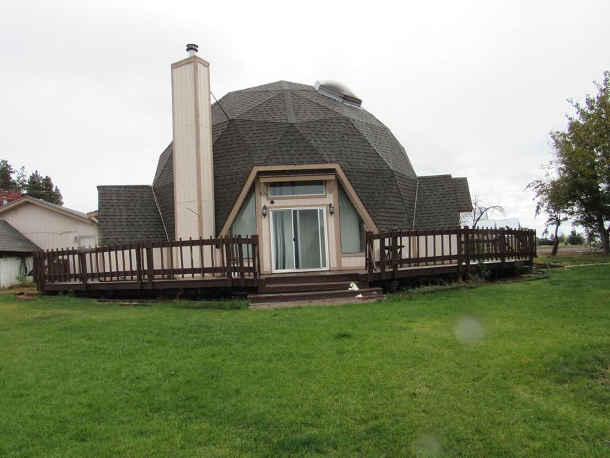 Great opportunity to make this unique home yours.  There are some things that need repaired and the seller is unable to do them. Home is livable just needs some TLC. The home is a Dome Home so if you ever wanted to see inside a dome home now is your chance!!  A 2 car garage with a  storage building and a car port.   Nice yard all fenced with several fruit trees and a nice group of spruce trees. There is a master bedroom and another downstairs with two more bedrooms upstairs. Agency Lake is across the street with access to a public boat ramp and also a camping facility on the lake.