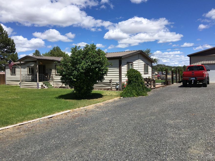 Fantastic corner lot on 3.22 acres. 3 acres of irrigated land & spacious 3 bedroom 2 bathroom manufactured home. Landscaped backyard featuring patio & deck with views of Barnes Butte. Large shop with room for an RV and 2 cars. Country living minutes from town.