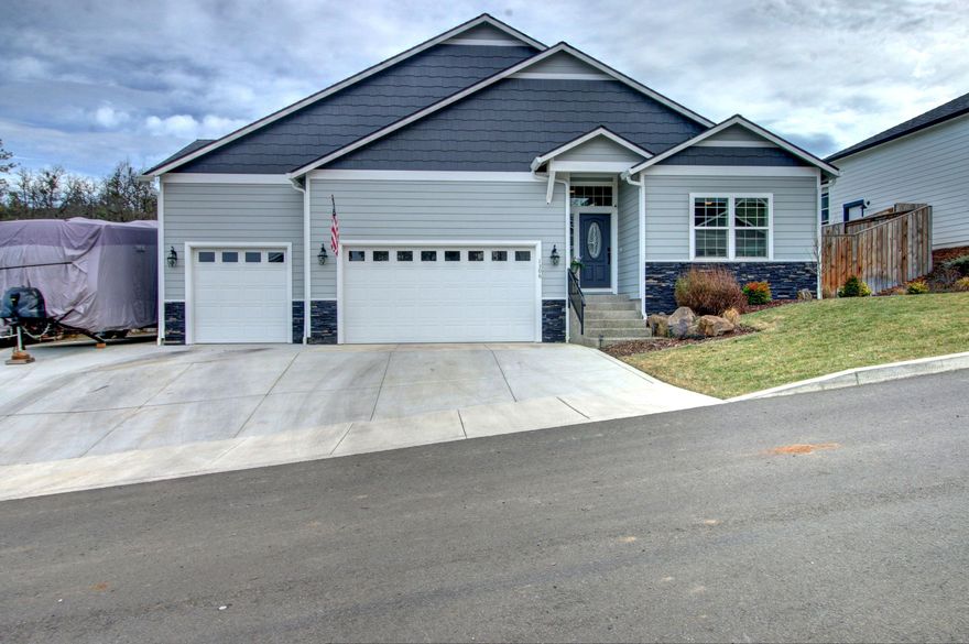 This beautiful 2019 2011 square foot home is nestled in the hills of Eagle Point overlooking Eagle Point and the golf course, plus no HOA's. This home is located on a dead end with only 6 custom houses. This home offers three-bedrooms, two bathrooms with large open living area and a split floor plan. The kitchen offers generous counter space, double oven, gas cooktop, and an oversized island. The huge master bedroom boasts a walk in closet and en suite bathroom which offers a beautiful shower and large soaker tub. Three-car garage has 19-foot ceilings, 120 square foot storage loft, and power locking garage doors. Concrete RV parking with an outlet, RV dump, and additional graveled parking space for utility trailers or extra vehicles. The beautiful private landscaped backyard has a covered patio, a 400 square foot deck with partial covering, a GFCI outlet, chandelier, lighted stairway and expansive views of Eagle Point and the golf course. Just below the deck enjoy the hot tub where you