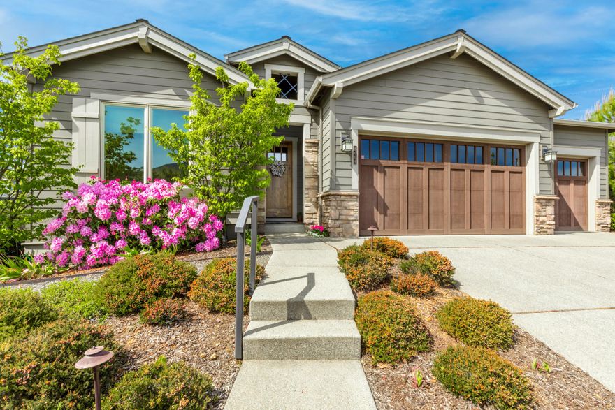 Welcome home to Bella Vista Heights! Meticulously built w/pride of ownership, this corner lot sanctuary boasts superior finishes. Enjoy a professionally landscaped yard w/native trees, 6-zone watering system, custom water feature & extensive rock work. Inside, vaulted ceilings, 8' solid core doors, beautiful wood floors & gas fireplace w/built in bookcases.  The gourmet kitchen w/Kitchen Aid gas range, fridge, island, undercounter lighting, pantry & eating area. Entertain on the covered patio, in the park-like backyard w/hardwired yard lighting & mature landscaping. Tons of storage in the upgraded & finished 3-car garage. Turn-key ready w/brand new washer & dryer included. This home is truly precious and in a prime location with extensive upgrades throughout!