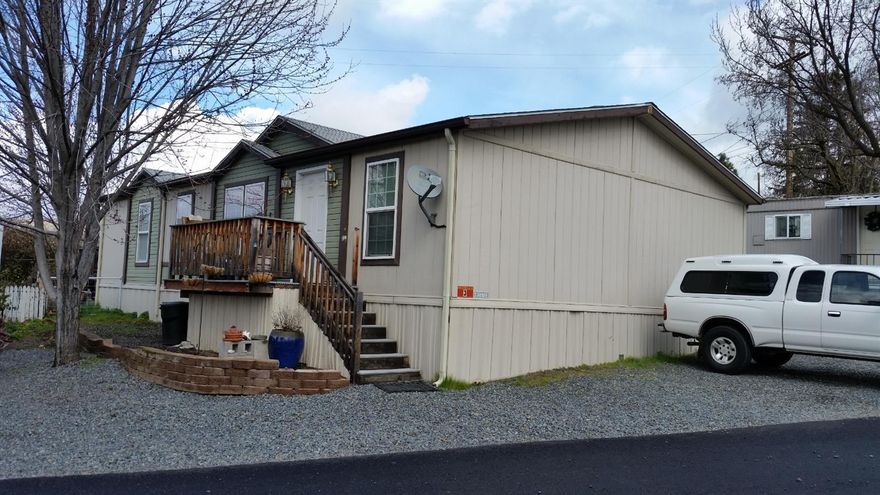 Location, Location, Location: Rural, Territorial and Mountain Views. Affordable nicely maintained (Park Model) 2003 built, 3 bedroom/2.0 bath (1,296 sq.ft.) home with lots of extras. Split floor plan, spacious kitchen with hardwood kitchen cabinets and bathroom vanities. Kitchen pantry, breakfast nook & bar, and built-in hutch in the Dining Room. Private Master Bedroom with walk in closest and Spacious Master bath. Lots of windows and Vaulted ceilings in this open floor plan. There's an interior utility room, central heating and A/C. Open rear deck area overlooking beautiful pastures with Mountain Views and privacy. New Park owners are upgrading and making improvements. Private Location, conveniently located on the Ashland City Boundary with Sunset views. Off street parking in front of the home. Very reasonable park space rent at $465/month, which includes water and sewer. RV parking is available thru the Park.