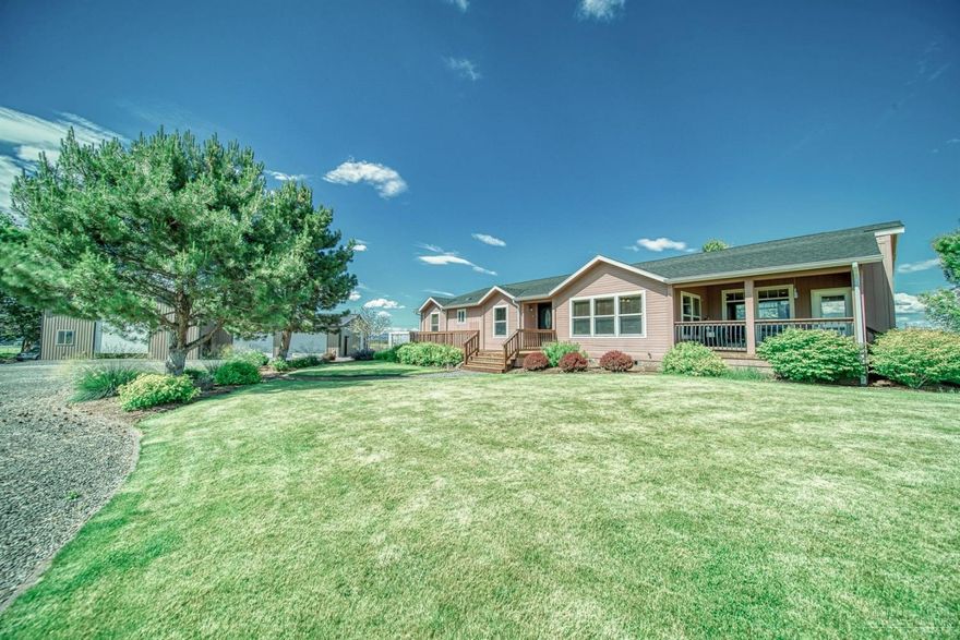 Immaculate Ranch on 128.49 acres with a full pivot, beautiful triple wide manufactured home with open great room, family room and 4 bedrooms/2 baths and large laundry room all with nice upgrades and stunning Cascade Views. Plenty of room for all of your equipment or toys with the huge fully finished shop with 2 reznor heaters and air compressor with attached finished garage.