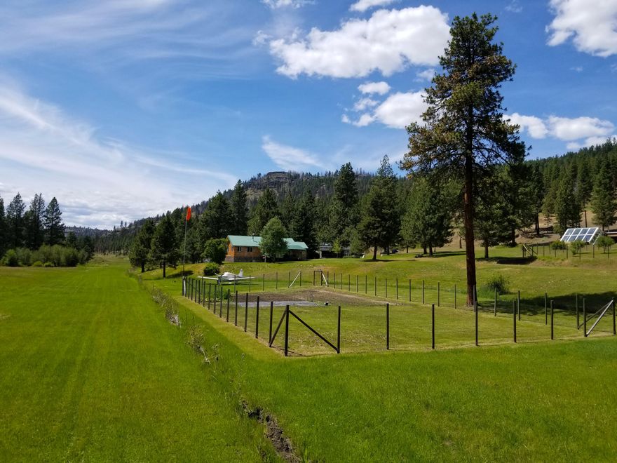 Amazing 160 Ac property with all facilities for living off grid, yet paved Forest Service Rd is only 1/2 mile away. Fly into your backyard utilizing the 3500 Ft. runway. Includes 2015 park model with insulated skirting, main home , Greenhouse and barn with all utilities. Pure spring fed water complements this property and provides irrigation. 13 ac of creek water rights included coming from year round flowing Murder's Creek running through the property. LOP tags included. Standing seam metal roofs on main home and barn provide for many future years of protection from snow and rain. Solar with 10 kw diesel generator as well as a second diesel generator to keep batteries sufficiently charged. Multiple battery storage provide consistent power to the homes. Frost free spigots are distributed throughout the property. Propane stove in park model helps to keep the home toasty in the winter months. Sale includes all appliances.