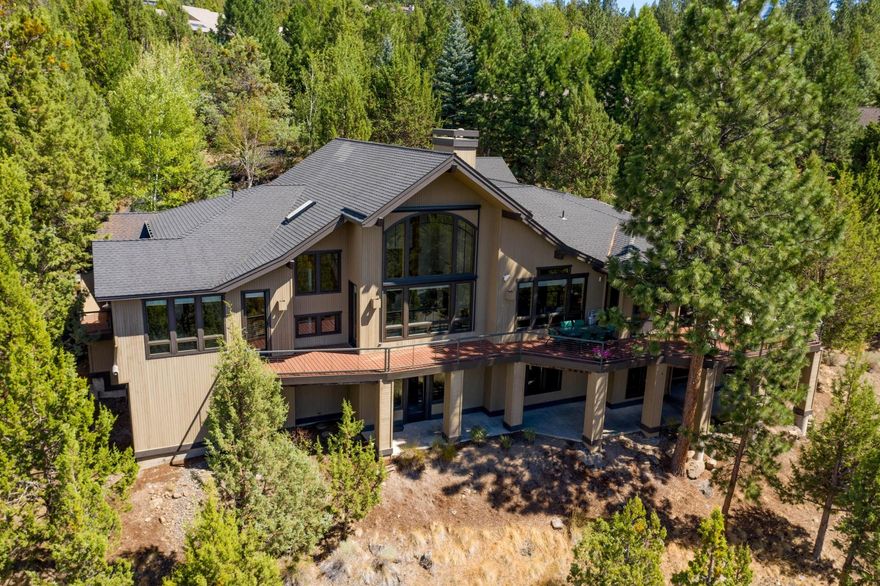 This spectacular Awbrey Butte property offers expansive views of the Cascade Mountain range from the spacious back deck, and throughout this gorgeous 5,329 sq ft home. With beautiful wood beams, high ceilings, and plenty of natural light, this amazing property offers two large living spaces connected with a see-through gas fireplace, an open kitchen with a granite island and breakfast nook, a separate dining area with vaulted wood ceilings, a private deck off of the master bedroom, and a bonus loft/office space with stunning views. The spacious downstairs level features a family room, two ensuite bedrooms with patio space, a large game/mud room, and wine cellar.