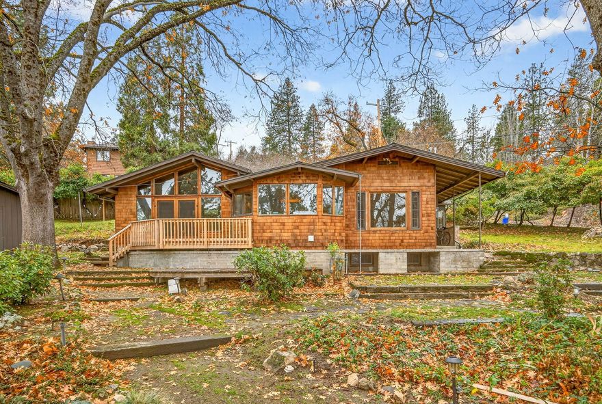 First time on the market in over 50 years! Mid-century cottage overlooking a large .67 of an acre lot above the University in beautiful Ashland, Oregon. Main house is approx. 1424 SF w/ two bedrooms and one bath, built in 1947. Great views looking out into the trees and the mountains afar. There is also a detached garage with a cozy ADU attached to it (separate electric meter and address). Sellers have divided the lot into two separate tax lots, .47 of an acre has the house and ADU and there is a .25 of acre lot that also could be developed or just left as one big lot! So much potential with this opportunity, be it a multi-generational setup or future site of your dream home! Property has T.I.D. irrigation rights and is close to hiking trails.