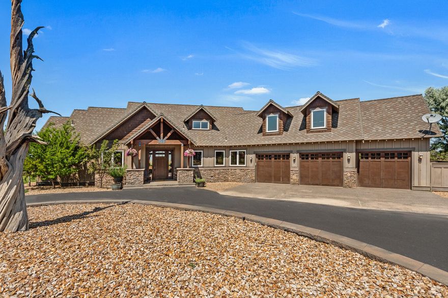 This gem in Powell Butte is a showstopper. Situated on the western slope of Powell Butte on almost five acres, the Cascade Mountains pop from every room. The custom home features a gourmet kitchen, a vaulted tongue and groove living room, several built-ins, and much more. The cozy primary bedroom sits on the first floor and boasts a fireplace, large walk-in closet, and a slider out to the back patio. Upstairs there are two additional bedrooms, a jack-n-jill bathroom, and a large bonus room. The home is wired with speakers throughout, sun shades off the back deck, and a generous three-car garage. The barn is custom built with four stalls and turnouts, automatic water with heat,  a tack room and feed room. Down at the front of the property is a large, outdoor arena for horses. The shop features five bays with an extra long bump out for an RV, 12-foot high doors, and guest quarters. There is RV parking with full hookups just to the side of the shop. This property is truly a must see.