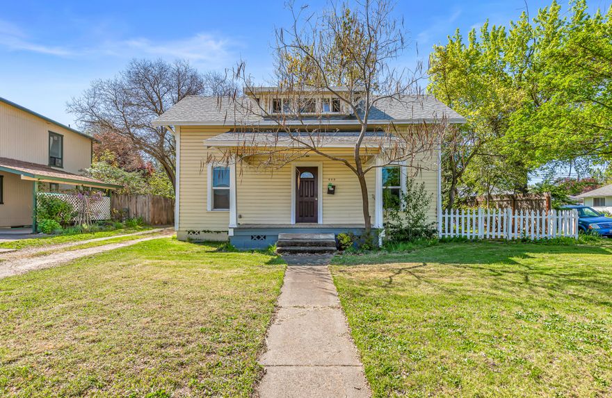 This charming three-bedroom, one-bathroom cottage offers a wonderful opportunity for investors or buyers looking to restore its original character. Filled with natural light, the home features an oversized living room with hardwood floors that flow into an adjoining dining area. The main-level primary bedroom and bathroom provide convenience, while two additional upstairs bedrooms offer flexible space for family or a home office. The kitchen features durable tile flooring and abundant cabinet space for all your storage needs. Situated on a spacious corner lot with mature landscaping, a fully fenced backyard and a detached single-car garage adds convenience and completes the property. This is an as-is sale.