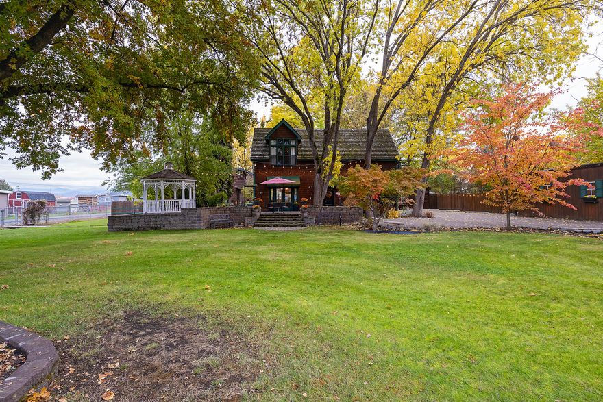 Located outside Historic Jacksonville on a quiet country lane. Travel past the gated entry down a cobblestone driveway that leads to a storybook setting. First detached cottage to the right would make a great office or hobby space. On the left is the main house with 3/2, 1,834 sq ft. Features include cedar shake siding, clear redwood interior walls, 10' ceilings & natural gas fp. The second cottage in back w/ 346 sq ft is currently being used as an AirBnb. Both the main home and cottage are permitted as a Bed&Breakfast, or keep as a private residence. Detached 3-car garage with bonus living area above. The .89 acre property is excellent for outdoor enjoyment with several lighted gathering areas. MID irrigation. Beautiful retreat setting just minutes from  Rogue X, shopping & situated in Jacksonville Elementary school district. Welcome home! One seller is a licensed RE broker in OR.