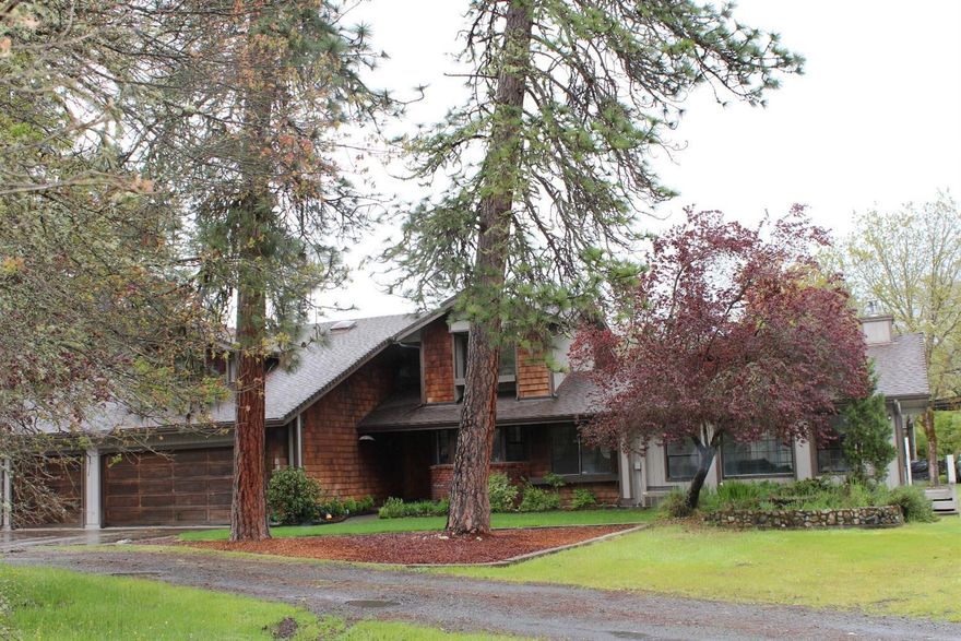 This Pacific Northwest Oasis is tucked away on 5.09 semi-private flat/useable acres, with a nice mix of pine and palm trees amidst a beautiful field of wildflowers. Light & bright, the main home features 3174 S/F, 4 bedrooms (master downstairs/3 upstairs), 2.5 baths, office/den, vaulted ceilings, living room with woodstove insert, huge family room with freestanding woodstove, skylights and sunroom. Three car garage, plus a separate area for a workshop or hobby room. The back yard is an Entertainer's delight featuring a brick patio, in-ground pool & spa, greenhouse, paddock & fenced pasture, covered RV port with hook-ups, fire pit, dog kennel, fenced garden, and a rock waterfall. PLUS... a 500 S/F Guest House that features 1 bedroom and 1 bath! Lots here for the $$$