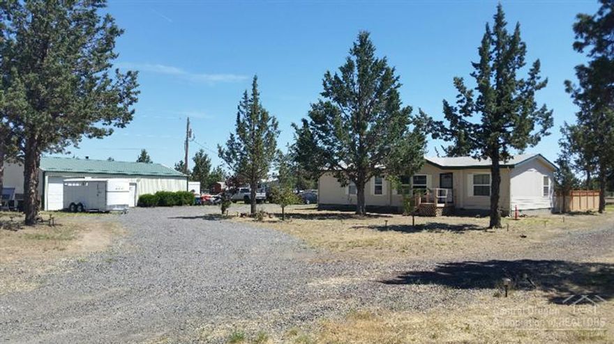Only minutes from the ranch entrance. Nice 3 bedroom, 2 bath M.H. 960 SF shop, chicken house, storage shed and barn. Entire property is perimeter fenced with an electronic gate, there's even room for an arena. Private fenced backyard and a nice deck in the back to relax on. Bring all your four legged friends! Don't miss this great property!!