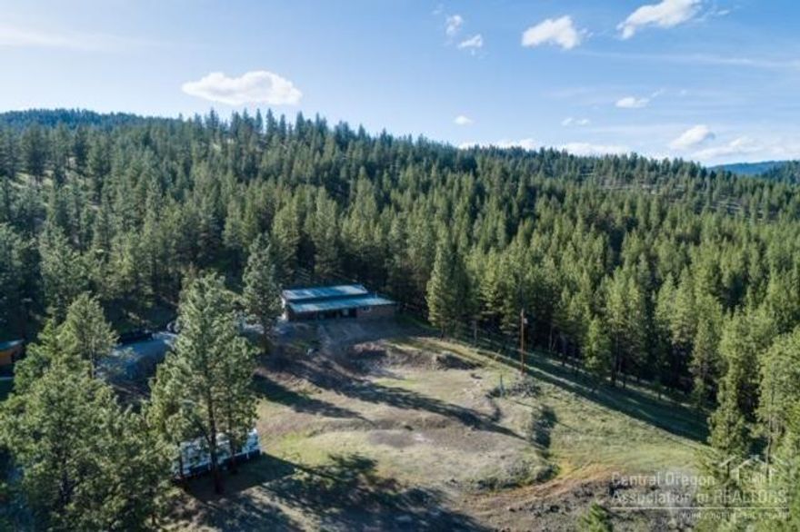 Enjoy abundant wildlife & pure serenity from this very unique 80 acre parcel.This hard to find buildable acreage inone of the most desired areas around Prineville. The parcel is timbered and has amazing views of the Mill CreekValley. It has a 20x48 shop , with 12 foot door, plus an attached apartment, two wells,16'x20' Barn, Chicken house. Minutes from Prineville city limits, public lands, and the lake.