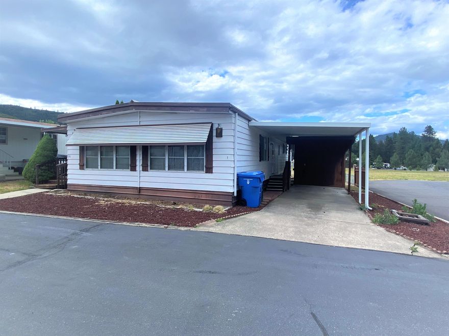 2 bedroom, 2 bath home located in a country mobile home park! Settled in the foothills of the Rogue Valley, you will love the rural feel of this 55+ park featuring a community garden, clubhouse & a fenced RV storage area. This 1344 square foot home boasts a large master with attached bath & indoor laundry. Outside you will find a large carport. Park has a community septic and well. Garbage included with space rent. Some maintenance required, inquire for more information!