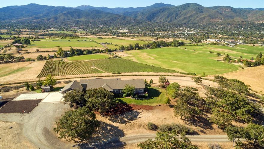 Introducing the Serenade Vineyard! This is your once in a lifetime opportunity to own one of the premier vineyards in Southern Oregon. Situated on 46+ acres just a few short miles from Downtown Ashland, this vineyard estate property boasts 22+/- Irrigated acres, 9 of those acres are planted with well established premium grape vines, another 17 acres that could be planted, and a custom 2900+ custom home with unmatched views! The home consists of 4 bedrooms, 3 baths with gorgeous hardwood floors, chef's dream kitchen with island, amazing entryway, wall to wall windows for all the views, built-in fireplace, and a separate guest entrance for extended family. The master suite boasts an large walk in closet and en suite bath with views to die for. Tons of privacy for the distinguished buyer along with a turn of the century barn, creek frontage, and includes two tax lots for all your needs. You simply do not find this much property so close to Ashland very often...Don't miss this one!