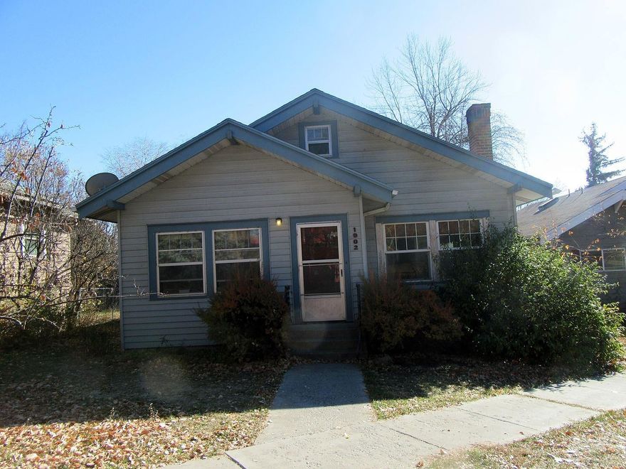 Charm and character abound in this darling home built in 1926 in Hot Springs. Featuring tile and wood floors, some vinyl windows, metal siding, geothermal heat. 2 bedrooms are on the main floor and each has an alcove for an office or hobby/sewing area and a full bath. Upstairs has built in twin beds and a bath plus tons of storage. Large kitchen with eating area. Utility in full basement, with finished room that could be a rec/tv room. Wood deck in back with pergola and raised bed gardens plus storage shed. Walking distance to grade school and park.