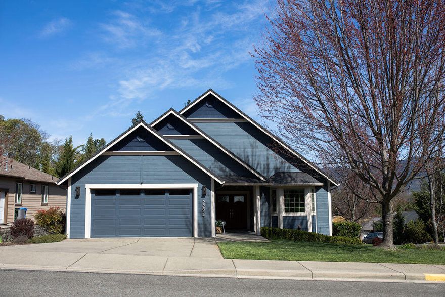 Welcome to 2294 SE Wyndham Way, a stunning 4-bedroom, 3-bathroom luxury home in the sought-after Meadow Wood Subdivision. Spanning an impressive 3,246 sq ft on a .23-acre lot, this home offers elegance and comfort at every turn. The vaulted ceilings and hardwood floors create an inviting and spacious atmosphere, complemented by double fireplaces for added warmth and charm. The expansive primary suite features balcony access, a large walk-in closet, and an oversized shower with dual heads. The kitchen is a chef's dream, complete with granite countertops and a double oven. Step outside to enjoy the beautifully landscaped backyard, perfect for relaxing or entertaining. With breathtaking views and exquisite details throughout, this home is a must-see. Schedule your private tour today!