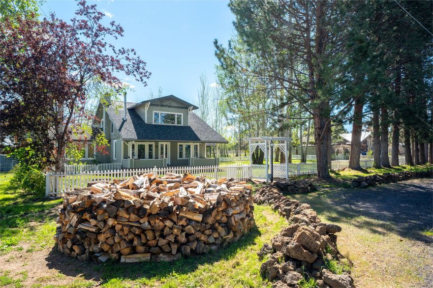 This picturesque estate w/ a 1920's farmhouse is set on 22 acres of sprawling beauty. The home boasts 3,808 sf, 4 bedrooms & 3 baths. It features ctrl. heating & cooling, a charming wood-burning fireplace & a private apartment with its own kitchen and bath - ideal for accommodating guests. The property also includes a vintage greenhouse, chicken coop, mature landscaping, fruit trees, and a 100 year-old red barn with cathedral rafters and ample space for hay and equipment. The acreage is fully fenced and cross-fenced, a 10 acre hayfield, 3 lg. grass pastures & 6 paddocks with shelters for your animals that are all irrigated. It includes 19.27 acres of water rights, a newer shared well, lush greenery, and a beautiful pond and stream. Just 15 min. from downtown Bend, yet a world away. This property offers plenty of wide open space and nearby BLM land perfect for riding and hiking. It's a horse lover's dream, and too special to be missed.