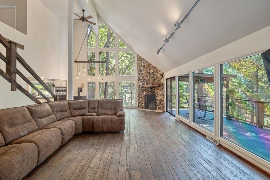 Nestled on 4.99 acres, this amazing 5b/3.5b 3,919sf home has so much charm! The great room's soaring windows showcase breathtaking mountain views. The main floor offers a spacious primary suite with a propane stove; a cozy fireplace & a propane stove in the great room; office/nook with wet bar; laundry room; beautiful kitchen with granite countertops, stainless-steel appliances & plenty of storage. Primary bath has a walk-in shower, tub, double sinks, heated floors & large walk-in closet. Upstairs has 3 bedrooms, full bath & a loft. Brand new carpet & bedroom flooring. The finished daylight basement includes a 5th bedroom, full bath, kitchen & family room with a private entrance—ideal for multi-generational living. Outdoor spaces shine with decks on both levels overlooking an amazing in-ground pool & water feature. Additional amenities include a detached garage, wine/canning cellar, barn with boiler, shed, generator, fruit trees, & more. A rare blend of charm, comfort & functionality!