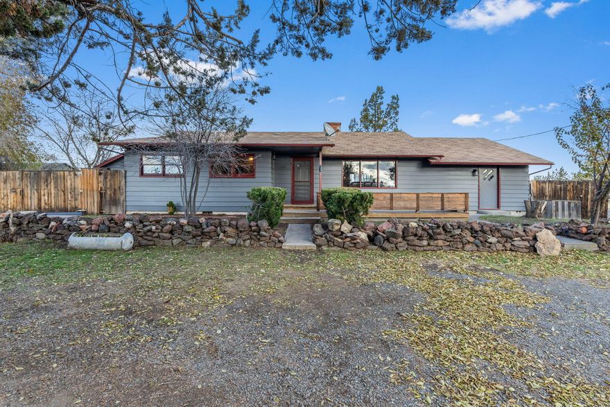 Take a step back in time to the 1950's era of quality craftsmanship and character. Nestled in a cozy corner of a peaceful friendly neighborhood, imagine sipping your coffee on the front porch gazing over the valley below, the peek-a-boo views demand your attention. Walk through freshly painted hallways, and you are welcomed into the spacious living room with a brick fireplace. The stunning hardwood floors, darling 1950's kitchen, and huge master bedroom with separate entrance are just a few of the highlights this house has to offer. With four bedrooms, and two bathrooms, this house has unlimited potential for living accommodations. Take a tour of the fully fenced  backyard, and you'll find a spacious 12x14ft storage shed, outside storage boxes for storing garden tools, and a designated fire-pit. The two car detached garage has built in work shelves, cabinets, and a separate back room that was used previously as an artists studio. Come look, you won't be disappointed.