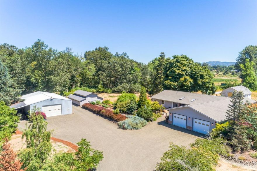 Situated in the scenic Umpqua Valley, known for viticulture, this 1.5 acre parcel has vineyard views. The recently updated single level home has 4 br and 2 ba, spacious living room, updated kitchen, lovely master suite, expansive deck and hot tub. The over sized two car garage is fully finished and heated. Loads of storage in the 768 sft barn. And there is a 1,500 sft shop with heat/ac. Raised gardens, chicken coop, RV and toy parking.