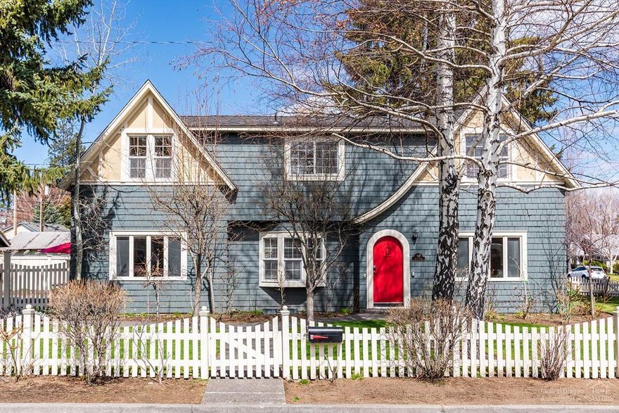 Located in the HEART of Bend, one block from Drake Park, this historic home originally built in 1922, exudes charm & architectural elegance throughout. Exquisite Great Room features soaring ceilings, dramatic, exposed beam work & wood-burn fireplace. Delightful light & bright kitchen with copper countertops, ample cabinetry & access to 2 separate outdoor living spaces. Main level Master Suite with walk-in closet & recently remodeled bathroom featuring chic subway tiled walls. Spacious formal dining room overlooks front professionally landscaped yard, complete with darling white picket fence. Two additional large bedrooms (one en suite) & 3rd full bath upstairs. Flex space with new carpet in basement, an ideal playroom/den/gym. Private deck with hot tub & fenced patio perfect for entertaining al fresco. Over-sized 2 car garage with shop space. Experience the ultimate Downtown Bend living & walk out your front door to Mirror Pond, fabulous restaurants, shops & trails. Truly a rare find!