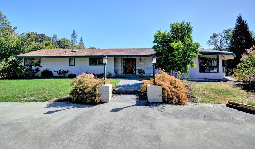 Privately set on 2.86 acres adjoining BLM, this is an amazing property with a 12' octagon Gazebo and deck overlooking a large pond. This lovely 2165 square foot one level home is gated and fenced, paved circle driveway, 30x20 3 car garage with additional storage room and a 12x20 workshop, a 36x34 RV garage with a 9x36 carport, storage loft and attached covered equipment area, 2, 10x12 garden equipment sheds, 2 large greenhouses. Mature landscaping with dozens of dogwoods, assorted established shrubs, fruit trees, lawns, and water and electricity around the whole perimeter of the property. The home has interesting lines with a welcoming entry, spacious living room with unique vaulted, wood beam ceiling, brick fireplace and a wall of picture windows. Den with woodstove, bright country kitchen with adjoining eating bar. Separate dining room with glass doors to the covered patio. Master suite, two additional bedrooms, an office, and laundry room complete the comfortable floor plan.