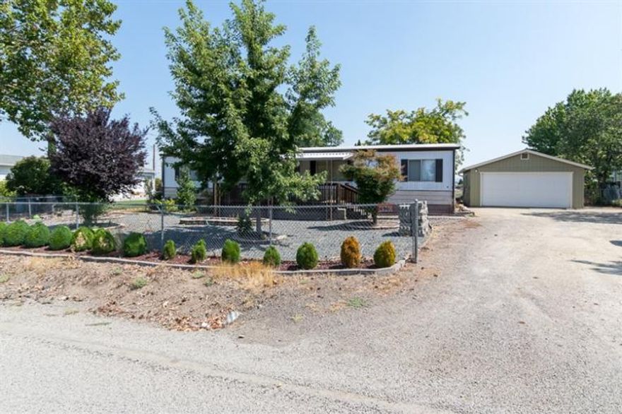 This is a wonderful opportunity for someone wanting RV parking with a well and on city services. This .33 of an acre has views of the Table Rocks in Central Point. There is a detached garage/shop already on the property with a nice yard. The 1979 double wide manufactured home needs some updating, but features a split floor plan, heat pump, forced air and a wood stove to make for a cozy winter. An electric stove and dishwasher, microwave, and gas hot water heater are also come amenities. Manufactured home has been moved twice. Cash or VA loan accepted only. Property is sold as is.