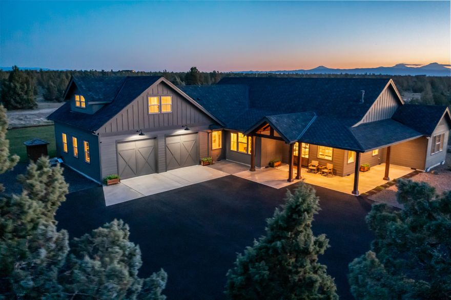 Experience the ultimate Central Oregon lifestyle on 20 acres in Powell Butte with jaw-dropping Cascade Mountain views. This custom home in a gated, fire-wise community delivers both peace of mind and luxury living, complete with a built-in fire-sprinkler system and custom finishes throughout. The vaulted great room and chef's kitchen with quartz counters, copper farmhouse sink, and island are designed for gathering. The primary suite is a private retreat with fireplace, soaking tub, and custom shower—all capturing the mountain backdrop. Thoughtful floor plan offers ideal bedroom separation, bonus upstairs space, and room for multigenerational living. Outdoor living shines with a covered patio perfect for sunsets and stargazing. Car collectors, hobbyists, and dreamers will love the 2,304 sq. ft. shop with two 14-ft doors and its own office. Just minutes from Redmond yet a world away, this property is more than a home—it's your private sanctuary in the high desert.