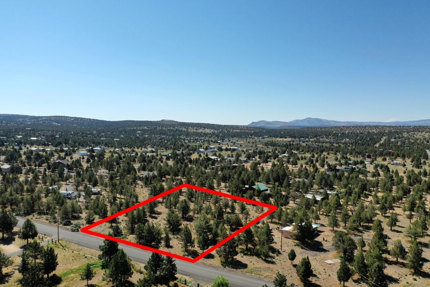 Discover a buildable 1.9-acre lot in Prineville Lake Acres 2, ideal for a Central Oregon home or vacation retreat. The property fronts a paved road and features a level, nicely treed landscape that supports a straightforward building process. Power is at the street and the community water system serves the area, creating a strong foundation for future development. Enjoy the quiet high-desert setting with easy access toward Prineville Reservoir for boating and recreation. Downtown Prineville's shopping, dining, and daily conveniences are only a short drive away. The neighboring lot (MLS# 220203656) can also be purchased, offering just under 4 acres combined for expanded building options or long-term land investment. A 10% down loan option is available for qualified buyers - an excellent opportunity to secure Prineville acreage in a desirable rural location.