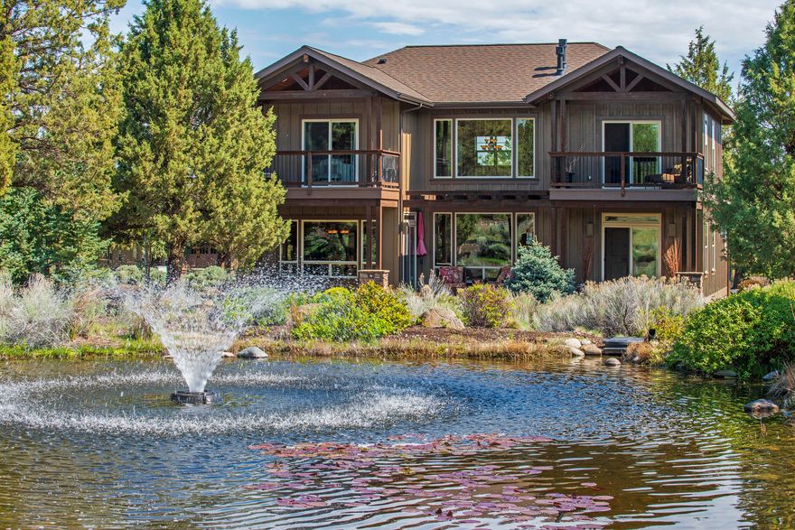 Stunning Eagle Crest home in immaculate condition backing to ponds, walking paths and peaceful common area! You can sense the quality and care put into this home from the moment you walk inside! Features included, high vaulted ceilings, expansive windows with excellent natural lighting, upgraded floor to ceiling dry stack rock fireplace, wood ceiling with exposed beams, wood wrapped windows and solid wood doors, stainless steel appliances and granite countertops, matching upper level covered decks, main level primary suite with coffered ceilings, cozy gas fireplace, accent lighting and private deck entrance, gorgeous hardwood floors, loft area and a large bonus room.  HOA includes front and back yard lawn care and landscaping, and the home can be used as a short term rental.  Don't miss all that Eagle Crest has to offer such as pools, golf, tennis courts, pickleball, sport courts, hiking and biking trails, equestrian, walking paths and access to the renowned Deschutes River!