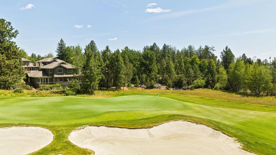 TOP VALUE IN THE COMMUNITY. BEST PRICE PER SQUARE FOOT! This Broken House townhome is ideally located behind the scenic 8th green. The home offers lovely wooded and golf course views, a private setting on a dead-end street, and low-maintenance, lock-and-leave convenience. The open-concept floor plan is filled with natural light and showcases vaulted ceilings, a gas fireplace, and rich wood floors. The main-level primary suite offers both comfort and convenience. Head downstairs to a second ensuite, additional bed/bath, plus a rare second living space—ideal for guests, a cozy den, or a hangout for the grandkids. Step outside to your private decks and relax in the hot tub while soaking in the peace and quiet. Broken Top Club offers optional memberships for golf, tennis, pickleball, a pool, fitness center, yoga studio, dining, and a full calendar of social activities. HOA cover's exterior building maintenance and front yard landscaping. Just show up and enjoy