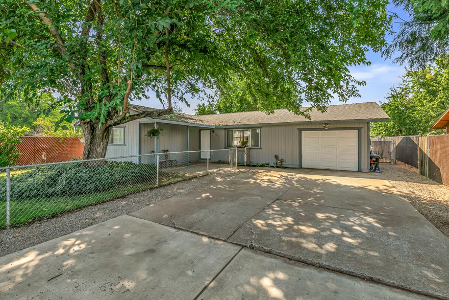 This charming 3 bedroom 1 bath home offers 1,054 sqft of thoughtfully designed living space on a .15 acre lot. A gated driveway with RV/trailer parking and fully fenced yard provide both privacy and convenience in the heart of town. The living room features laminate hardwood floors, adjustable recessed lighting, and is hard wired for sound, while the kitchen and dining area have easy to clean tile flooring. All bedrooms are carpeted for comfort along with fresh interior and exterior paint that give the home a crisp, modern feel. A sliding door off the kitchen opens to a private patio and garden area with raised beds, perfect for relaxing or entertaining. The oversized 1 car garage is insulated and finished, complete with built in shelving, hanging storage, two workbenches, and a dedicated laundry space. Recent upgrades include a ductless mini split system and water heater installed in 2023. Combining comfort, location, and versatility, this is a home you won't want to miss!!