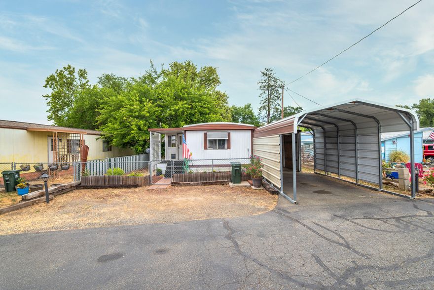 Welcome Home to this charming residence in the Riverhaven Mobile Home Park! This 1981 built home has been well-maintained and is ready for a new owner. Featuring two bedrooms and one bath, this 689 square foot single wide home is move-in ready and includes a large carport and small fenced garden. Inside you'll find an open living room and kitchen area which includes all new paint and stainless steel appliances.  Two bedrooms plus bathroom with tub shower, laundry space with stacking, front loading washer and dryer plus heating and cooling system to keep you comfortable all year long! Outside includes a small storage area and a fenced yard perfect for small pets!  Did I mention the super low space rent? All this conveniently located just minutes from shopping, parks and the Rogue River! Call today to make this your home!