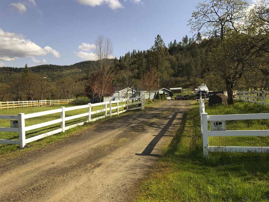 Peaceful and serene! 1,512 sqft home. 3 bdrm, 2 bath with cathedral ceilings throughout. South facing kitchen & dining w/ skylights and large windows. Large covered deck off kitchen. New wood stove easily heats home. Lifetime wood supply. New 40 year comp roof, high speed internet. Garage/shop is fully finished, has heat and built in compressed air. Room for horses. 60 GPM well. Multiple outbuildings, 40x25x10 high garden fence with auto sprinklers. Paved road.