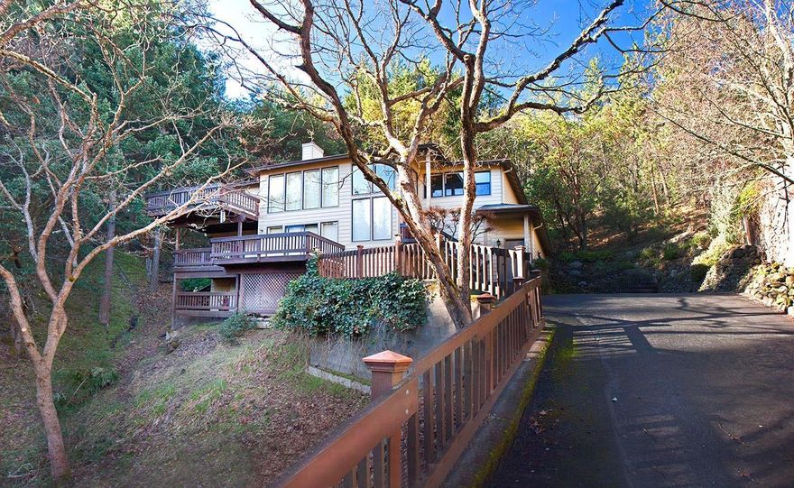 This wonderfully comfortable mountain nest combines views, light and privacywith nature on all sides. It's close to Ashland's best hiking and biking trails and just minutes to Lithia Park. The home's main level has a living room with fireplace, dining room, kitchen with eat-in area, half bathroom and spacious master suite with luxury bath, shower, walk-in closet-all surrounded by decks and views. The lower level has a family room, two more bedrooms with a full bath and deck, laundry room and two-car attached garage with workshop space. All is well-maintained including a new heat pump in 2008, newer roof and irrigation system with regulator. Outside are multiple view decks, a rear terrace and even a private picnic gazebo. Serenity awaits you.