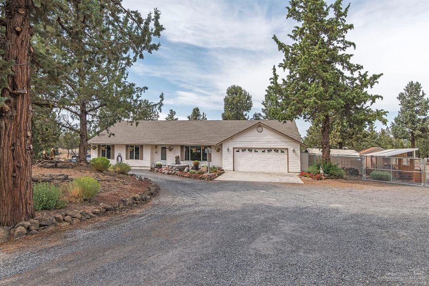 Beautiful immaculate custom home on 2.4 private acres. Open and bright, efficient kitchen with newer stainless appliances, fridge included. Quartz countertops, hardwood & carpet flooring. 2 masters, vaults, plant shelves. Heat pump with AC, ceiling fans, all this plus french doors that access to a stamped concrete deck with enclosed hot tub. Detached sunroom, covered stone accents BBQ area, screened gazebo, three water features, two west coast metal garages, 24x31 10 ft. doors. 20x21 8 ft. doors, 22x26 RV carport, extra storage shed is approx. 10x8. Covered dog kennel, automatic sprinklers, fenced with chain length fence. This property you do not want to miss, perfect for all the toys. This is THE property!
