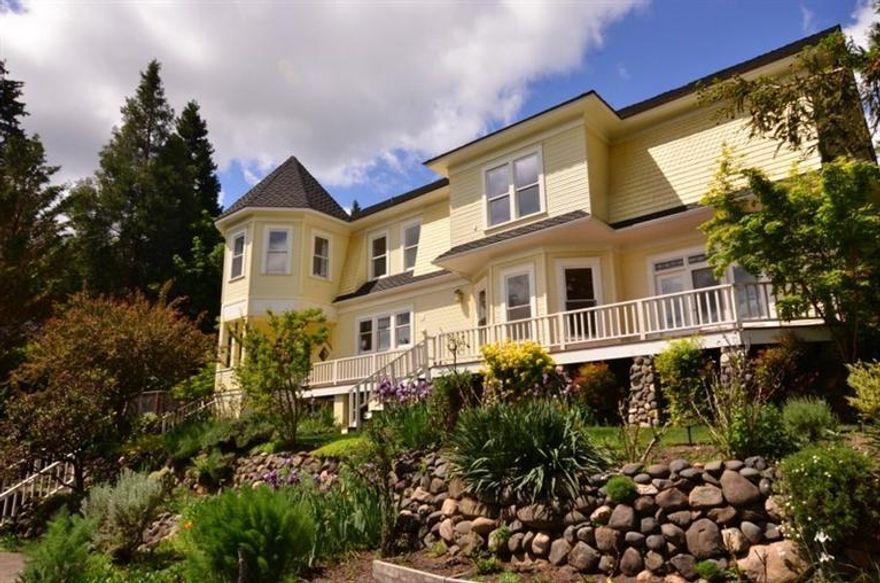 One of Ashland's most stunning vintage homes located in prime historic neighborhood on large 1/3 acre lot. Only a few blocks to the Plaza for those that want to be close to town center. This visually striking home previously won the Distinguished Architectural Preservation award from the Historical Society. Described as a Queen Anne with Dutch Colonial Revival details this home was carefully renovated with 2-story turret, wrap-around porch & veranda. Gorgeous grounds, rock walls, lawn areas, mature flowering trees, greenery & separate spacious fenced garden area with raised beds. The interior has original clear grain fir floors, granite gourmet kitchen, great room with fireplace & breakfast area. Lovely formal living room with French doors leads to wrap-around porch. Elegant formal dining room. Wonderful master suite with large circular sitting room with soaring ceiling and expansive views. Separate guest quarters .Beautiful mountain views from most rooms of this lovely home.